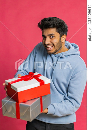 Smiling man presenting birthday gift present box stretches out hands, promotion discount sale Smiling man presenting birthday gift present box stretches out hands, promotion discount sale 132409654