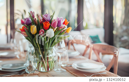 Easter concept. Glass vase bouquet pink yellow tulips, cradling pastel Easter eggs, set against modern grey backdrop. paste blank. Holidays, copy space, design greeting cards, art minimalist style Easter concept. Glass vase bouquet pink yellow tulips, cradling pastel Easter eggs, set against modern grey backdrop. paste blank. Holidays, copy space, design greeting cards, art minimalist style 132410032