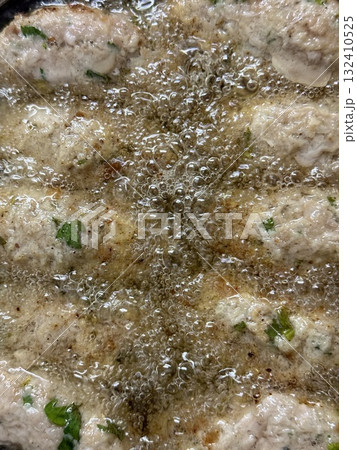 Close-up of raw meatballs being deep-fried. Traditional Cypriot food, Mediterranean cuisine. 132410525