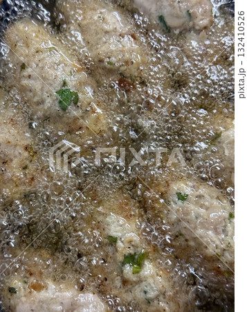 Close-up of raw meatballs being deep-fried. Traditional Cypriot food, Mediterranean cuisine. 132410526