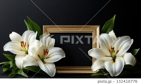 Empty golden frame surrounded by white lilies on a black background, symbolic of remembrance or tribute. Empty golden frame surrounded by white lilies on a black background, symbolic of remembrance or tribute. 132410776