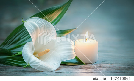A white lilies calla flower with water droplets beside lit candle, evoking emotion and memory. Funeral symbol A white lilies calla flower with water droplets beside lit candle, evoking emotion and memory. Funeral symbol 132410866