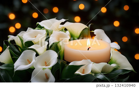 A white lilies calla flower with water droplets beside lit candle, evoking emotion and memory. Funeral symbol A white lilies calla flower with water droplets beside lit candle, evoking emotion and memory. Funeral symbol 132410940