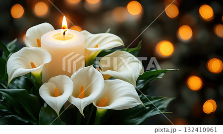 A white lilies calla flower with water droplets beside lit candle, evoking emotion and memory. Funeral symbol A white lilies calla flower with water droplets beside lit candle, evoking emotion and memory. Funeral symbol 132410961