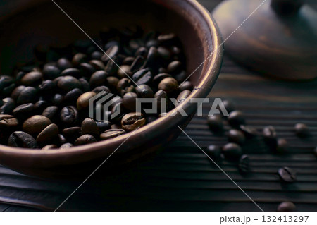 Coffee beans in a clay bowl on a wooden table 132413297