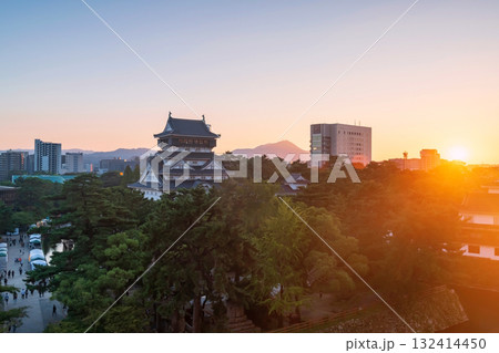 Kokura Castle by park and cityscape at sunset, Kitakyushu 132414450