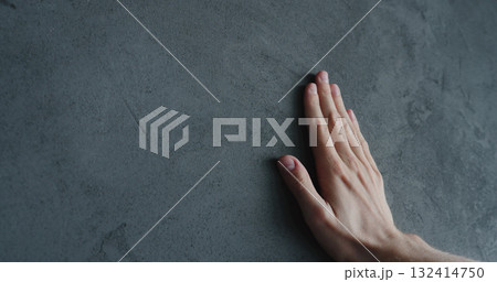 man hand touches decorative concrete finish 132414750