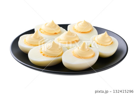 hard boiled chicken eggs with mayonnaise in a black plate isolated on a white background. 132415296