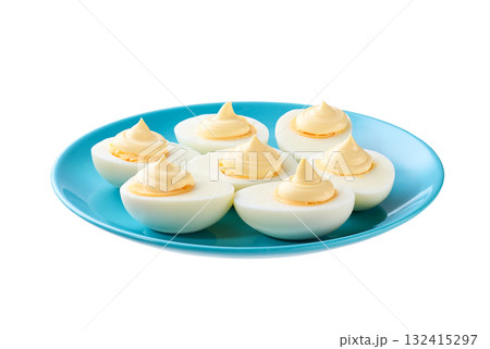 Boiled chicken eggs with mayonnaise in a blue plate isolated on a white background. Boiled chicken eggs with mayonnaise in a blue plate isolated on a white background. 132415297