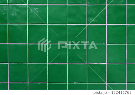 Green ceramic tile background. Old vintage ceramic tiles in green to decorate the kitchen or bathroom Green ceramic tile background. Old vintage ceramic tiles in green to decorate the kitchen or bathroom 132415765