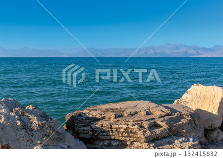 Large rocks in the artificial harbor bay near the village of Roda on the island of Corfu Large rocks in the artificial harbor bay near the village of Roda on the island of Corfu 132415832