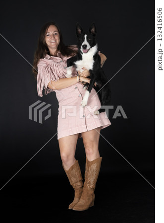 puppy border collie and woman 132416506