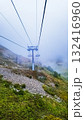 A ski lift ride in the mountains in the fog 132416960