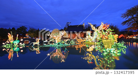 Chinese Garden illuminated at night with colorful figurines reflected on water, Chinese Pavilion and Stadium tower Chinese Garden illuminated at night with colorful figurines reflected on water, Chinese Pavilion and Stadium tower 132417395