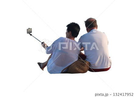Couple sitting taking selfie with smartphone stick 132417952