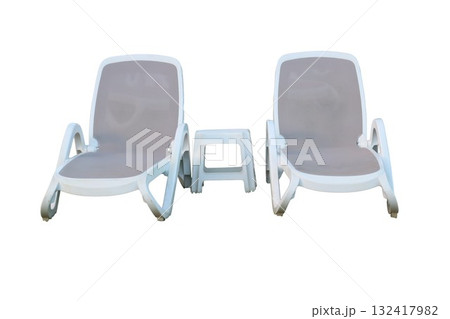 Two lounge chairs and side table for summer relaxation Two lounge chairs and side table for summer relaxation 132417982