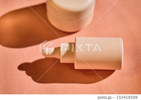Bottles of facial serum in the beautiful sunset light. Bottles of facial serum in the beautiful sunset light. 132418509