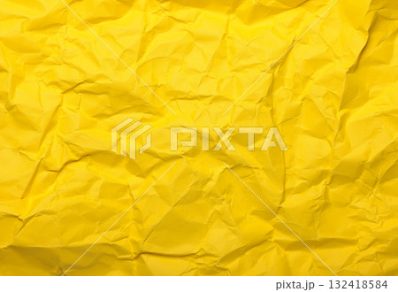 Yellow crumpled paper creating an abstract texture background Yellow crumpled paper creating an abstract texture background 132418584