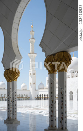 Vertical detail of white mosque minaret framed by white arc, United Arab Emirates 132418928