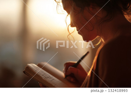 Close-up of woman writing in notebook 132418993