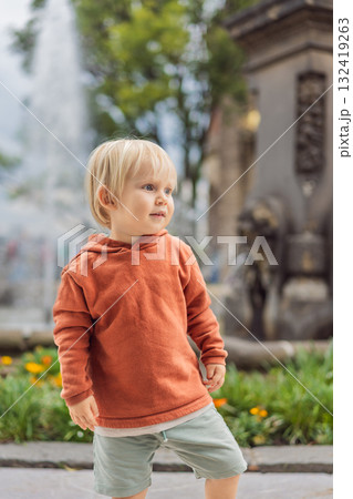 Little toddler tourist near Chapultepec Castle in Mexico City, exploring the landmark during family travel. Cultural heritage and tourism concept 132419263
