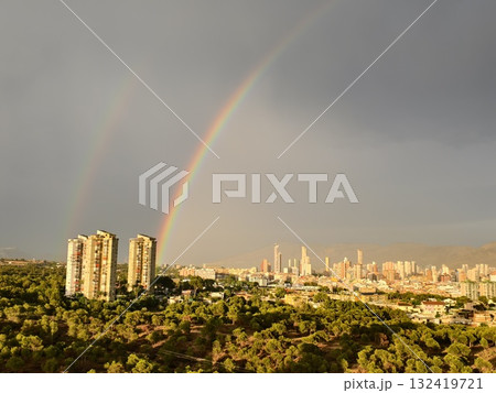 colorful urban skyline with emerging hope, city skyline illuminated by rainbows amid stormy clouds 132419721