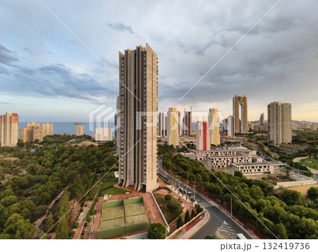 tall buildings amid lush trees, residential towers surrounded by dense greenery and quiet streets tall buildings amid lush trees, residential towers surrounded by dense greenery and quiet streets 132419736