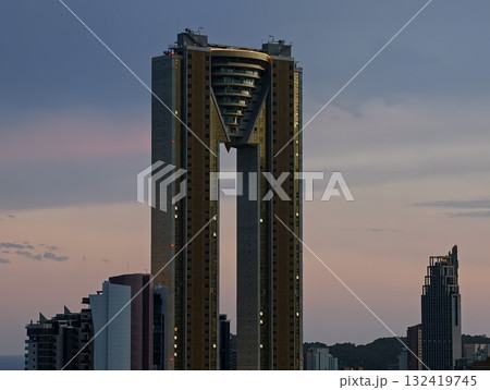 cityscape at dusk, majestic tower with concrete facade amidst quiet residential neighborhood at dusk cityscape at dusk, majestic tower with concrete facade amidst quiet residential neighborhood at dusk 132419745