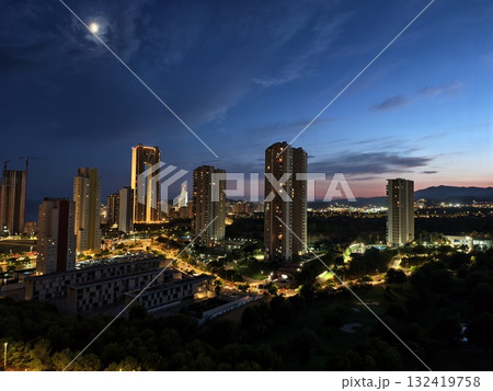 city skyline under moonlight glow, cityscape at dusk with glowing buildings and tranquil 132419758