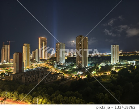 skyscrapers glow with celebration, vibrant metropolis illuminated by twin beams and festive skyscrapers glow with celebration, vibrant metropolis illuminated by twin beams and festive 132419762