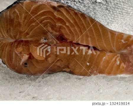 freshly cut salmon steak displayed on crushed ice with vibrant coloration and sustainable sourcing 132419814