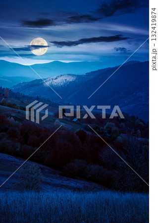 mountain landscape of countryside in autumn at night. mysterious view of range with dappled light on forested slopes in fall foliage in full moon light. spooky place with rolling hills mountain landscape of countryside in autumn at night. mysterious view of range with dappled light on forested slopes in fall foliage in full moon light. spooky place with rolling hills 132419874