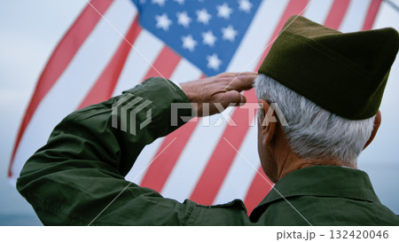 USA Flag Wawing Over The Sea In Front Of A Retired Soldier USA Flag Wawing Over The Sea In Front Of A Retired Soldier 132420046