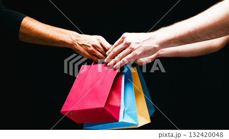 Multiple Shopping Bags Hand Exchange on Black Friday Day Multiple Shopping Bags Hand Exchange on Black Friday Day 132420048