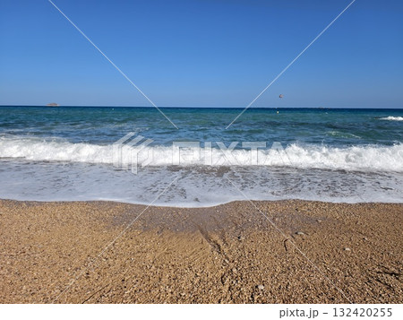 gentle coastal beach scene at sunrise, peaceful sandy beach with morning light and calming waves 132420255