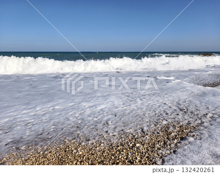 foamy waves over pebbled shore, dramatic ocean wave action over pebble beach environment captured foamy waves over pebbled shore, dramatic ocean wave action over pebble beach environment captured 132420261