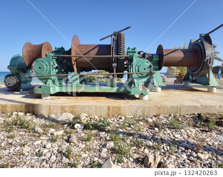 old rusty winches and drums along shoreline tell stories of industrial abandonment and decay 132420263