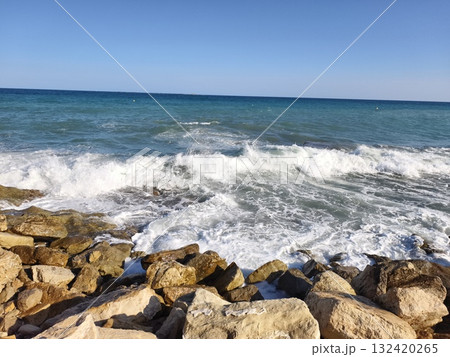 energetic waves exploding on rocky shoreline for dramatic adventure and surf advertising visuals 132420265
