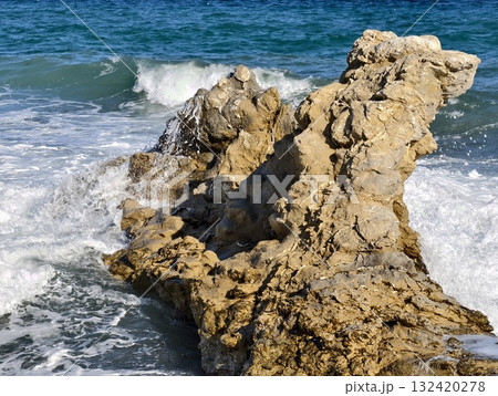 beach scene imagery, coastal waves and rocks depiction, serene shoreline with waves and textured 132420278