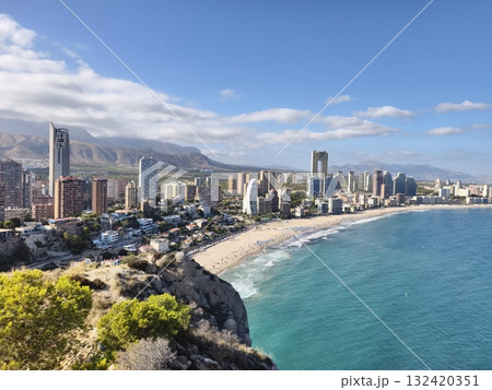 beachside skyline scene, idyllic sunny coastline featuring turquoise waters and bustling hotels 132420351