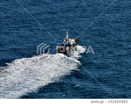 chase over ocean, coast guard pursuing vessel swiftly, rapid pursuit of target across deep sea chase over ocean, coast guard pursuing vessel swiftly, rapid pursuit of target across deep sea 132420363