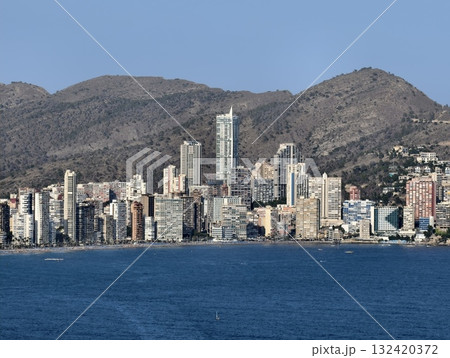 bright coastal area with lively vibe, vibrant daytime waterfront with highrise buildings and active 132420372