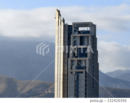 brutalist facade with rhythmic modules, geometric building featuring deep windows and stark shadows 132420392