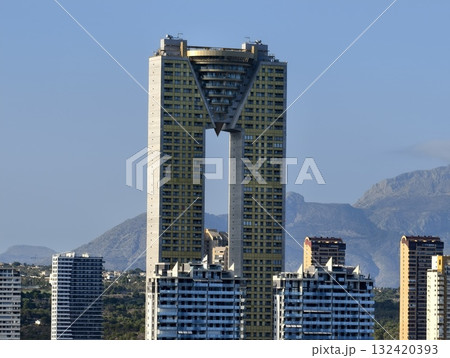 architectural structure with exposed columns, symmetrical arch connecting towers with concrete architectural structure with exposed columns, symmetrical arch connecting towers with concrete 132420393