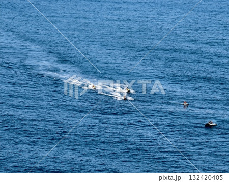 minimalist scene of tiny boats on open ocean, vast blue sea with small boats and serene surface minimalist scene of tiny boats on open ocean, vast blue sea with small boats and serene surface 132420405