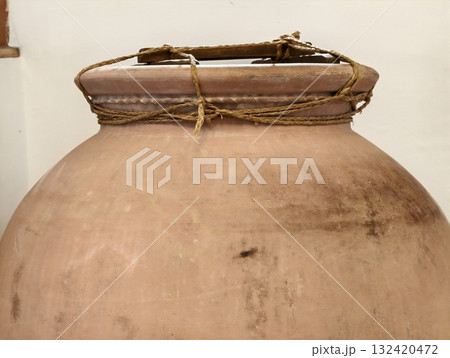 old terracotta jar, aged rustic clay storage vessel with textured surface and charming handle design 132420472