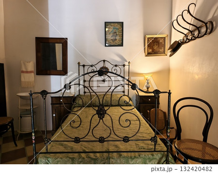 cozy bedroom ambiance, charming bedroom scene featuring ornate headboard and inviting textiles 132420482