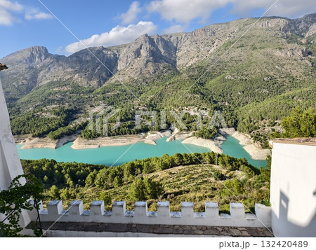terrace overlooking mountainous reservoir, terrace offering views of turquoise water and rugged terrace overlooking mountainous reservoir, terrace offering views of turquoise water and rugged 132420489