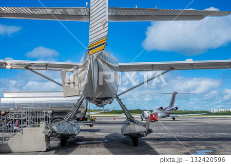 Seaplane on tarmac ready for departure at an airstrip under clear blue skies in the Bahamas 132420596