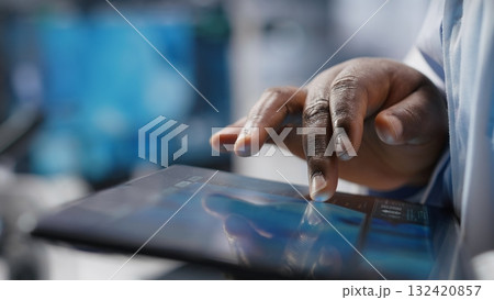 Black female researcher analyzes molecular biology samples in a biotechnology lab. Experiment showcases innovation in genetics research and healthcare solutions through analysis. 132420857
